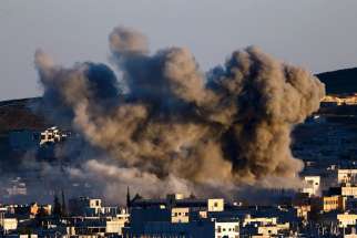 Smoke rise over Syrian town of Kobani after an Oct. 21 airstrike.