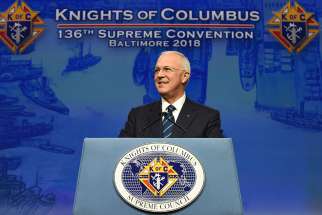  Carl Anderson, CEO of the Knights of Columbus, smiles as he addresses attendees Aug. 7 at the 136th annual Knights convention in Baltimore. Anderson spoke of the charitable works of the Knights, their ongoing pro-life commitment and pledge to support persecuted Christians in Iraq and Syria.