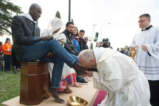Pope Francis kisses the foot of a refugee during Holy Thursday Mass of the Lord&#039;s Supper at the Center for Asylum Seekers in Castelnuovo di Porto, about 15 miles north of Rome March 24, 2016.
