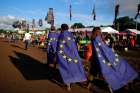 Revellers wrapped in European Union flags walk at Worthy Farm in Somerset during the Glastonbury Festival, Britain, on June 22, 2016. 