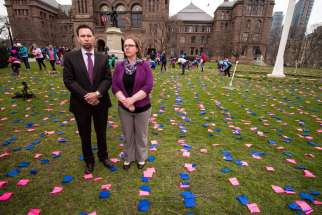 We Need A Law campaign director Mike Schouten and media relations assistant Niki Pennings on the front lawn of Queen’s Park, where the campaign had arranged a display of 100,000 pink and blue flags to represent 100,000 abortions performed in Canada each year. The We Need A Law parent organization, ARPA Canada, is going to court to challenge an Ontario law that limits access to abortion information.