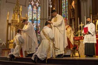 Over 200 priests in attendance for the ordination laid their hands on Alexander MacDonald and Raymond So, May 12, at St. Michael&#039;s Cathedral Basilica. 