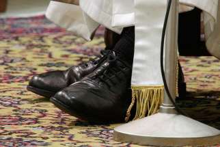 The shoes of Pope Francis are seen as he conducts a general audience in the Paul VI hall at the Vatican on March 16, 2013. 