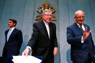 Jean-Baptise de Franssu, left, current president of the Vatican bank, former President Ernst Von Freyberg, right, and Australian Cardinal George Pell, prefect of the Vatican Secretariat for the Economy, leave at the end of a news conference at the Vatican July 9, 2014. The Vatican said it will separate its bank&#039;s investment business from its church payments work to try to clean up after years of scandal, including allegations of money laundering and tax evasion. 