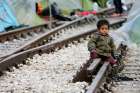 A child sits on railroad tracks near a makeshift camp for migrants in late March at the Greek-Macedonian border near the village of in Idomeni, Greece. Migrant children, the most vulnerable and fragile victims of war and persecution, will be at the heart of the Catholic Church&#039;s annual day of reflection and prayer on the situation of migrants and refugees.