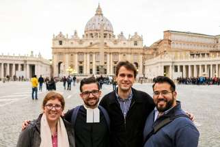 Katie Prejean-McGrady, De La Salle Christian Brother Javier Hansen, Chris Russo and Nick Lopez, some of the young adults from the United States participating in the Vatican&#039;s pre-synod meeting, posed March 21 in front of St. Peter&#039;s Square. 