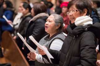 Filipinos worship during a Simbang Gabi Mass at Holy Rosary Cathedral in Vancouver, British Columbia, Dec. 15.