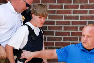 Police lead suspected shooter Dylann Roof, 21, into the courthouse in Shelby, N.C., on June 18, 2015.