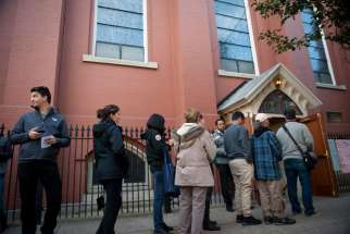 Voters wait outside a polling location for the presidential election Nov. 8 shortly after polls opened at Annunciation Church in Philadelphia.