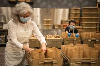 Rebecca Ferguson, left, and Eileen Wong are among The Good Shepherd employees doing what is necessary to help feed the homeless and needy in downtown Toronto.