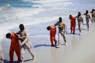 Islamic State militants lead what are said to be Ethiopian Christians along a beach in Libya in this still image from an undated video made available on a social media website April 19. 
