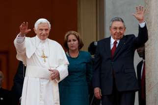 Pope Benedict XVI and Cuba&#039;s President Raul Castro gesture to the media as they appear for a photo opportunity outside the Palace of the Revolution in Havana March 27, 2012.