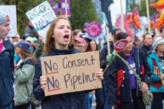 A protester makes her viewpoint known about the proposed Kinder Morgan Trans-Mountain pipeline last fall in Vancouver.