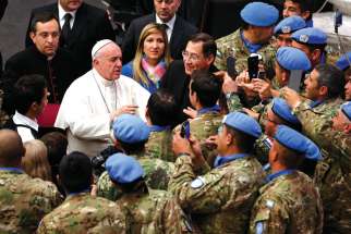 Pope Francis greets UN peacekeepers from Argentina during his general audience in Paul VI hall at the Vatican Dec. 14. In his World Day of Peace message, the Pope calls for a new political order based on peace and non-violence.