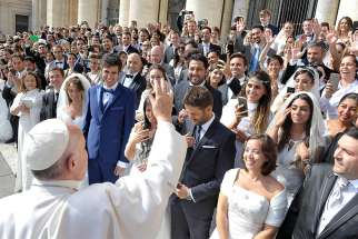Pope Francis greets newly married couples during his general audience in St. Peter&#039;s Square at the Vatican Sept. 30, 2015.