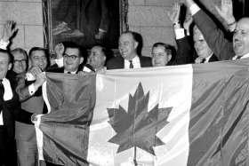 Members of Parliament celebrate with the new flag after the Liberals invoked closure to end the flag debate in the House of Commons. 