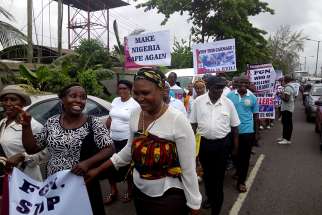 Nigerians carry placards during a May 22 protest in Lagos against the killing of innocent citizens, presumably by herdsmen, in some parts of the country. Catholics marched in various cities around the country.