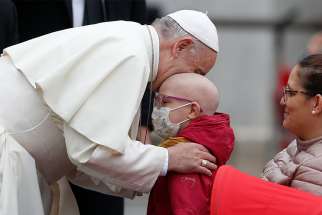 Pope Francis embraces a sick boy during his general audience in St. Peter&#039;s Square at the Vatican Oct. 17. 