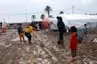 Young internally displaced Iraqis try to dig a drainage trench after heavy rains in early November at a camp in Baghdad.