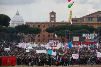 The dome of St. Peter&#039;s Basilica is seen in the distance as people attend the Family Day rally at the Circus Maximus in Rome Jan. 30. The rally was held to oppose a bill in the Italian Senate that would allow civil unions for homosexual and heterosexual couples.
