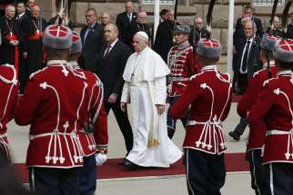 Pope Francis walks with Bulgarian President Rumen Radev during a welcoming ceremony in the square outside the presidential palace in Sofia, Bulgaria, May 5, 2019. 
