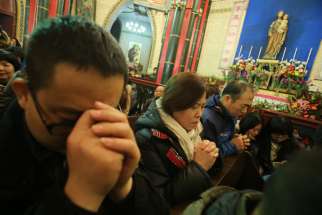 People pray during Mass at a Catholic church in Beijing in 2014.