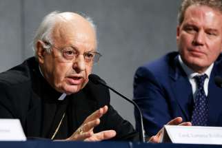 Cardinal Lorenzo Baldisseri, secretary-general of the Synod of Bishops, speaks during a Sept. 18 Vatican news conference to announce synod changes. Also pictured is Greg Burke, Vatican spokesman. Pope Francis has issued an apostolic constitution, updating the rules of how the synod is prepared for, conducted and implemented. 
