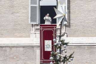 The Christmas tree is seen as Pope Francis leads the Angelus prayer from the window of his studio overlooking St. Peter&#039;s Square at the Vatican Dec. 2. The pope lit an Advent candle as he launched the Christmas campaign, &quot;Candles for Peace in Syria,&quot; an initiative of Aid to the Church in Need.