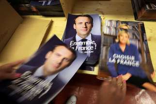 A civil servant prepares electoral documents for the May 7 second round of the French presidential election between Emmanuel Macron, left, and Marine Le Pen, in Nice, France, on May 3, 2017.