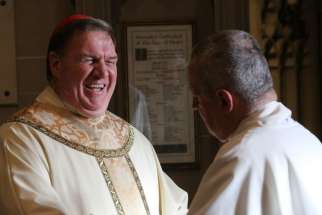 Cardinal Joseph W. Tobin smiles as he greets a clergyman before his Jan. 6 installation Mass at the Cathedral Basilica of the Sacred Heart in Newark, N.J.