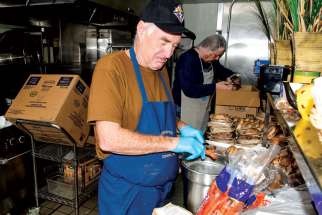 Gerald Jordan from the Knights of Columbus, Toronto Council 1388, helps out in the kitchen at Good Shepherd Ministries, where the annual Boxing Day feast will feed more than 1,200.