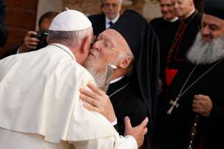 Pope Francis exchanges greetings with Ecumenical Patriarch Bartholomew of Constantinople as he arrives for an interfaith peace gathering at the Basilica of St. Francis in Assisi, Italy, Sept. 20. The peace gathering marks the 30th anniversary of the first peace encounter in Assisi in 1986.