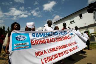 embers of Amistad, a nongovernmental organization, and other religious and women&#039;s rights organizations hold a banner as they gather near the headquarters of the Economic Community of West African States (ECOWAS) during a protest in Abidjan, Ivory Coast , May 19. Protesters demanded that West African leaders work together to ensure the release of more than 200 school girls who were abducted by the Boko Haram in Nigeria in April.