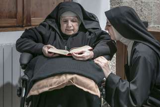 Sister Maria Giuseppina (left) and Sister Maria Caterina (right) are among 10 remaining nuns in a convent on the island of Sardinia who are breaking their silence and embracing the internet in an effort to ensure their order’s survival. This photo is from an exhibition being held at the Santa Chiara convent in Sardinia.