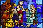 The Adoration of the Magi is depicted in a stained-glass window at Holy Family Church in New York. The feast of the Epiphany of the Lord is observed Jan. 7.