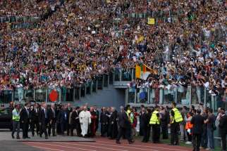 Pope Francis arrives for an encounter with more than 50,000 Catholic charismatics at the Olympic Stadium in Rome June 1. The pope knelt onstage as the crowd prayed over him by singing and speaking in tongues. During the event the pope acknowledged he had once been uncomfortable with the charismatic movement. 