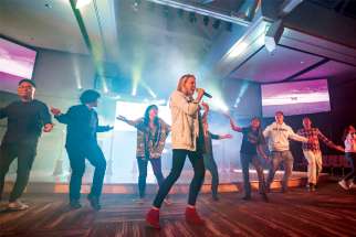 Catholic speaker and musician Emily Wilson is joined on stage by young adults at the One Rock 2.0 conference in Calgary.