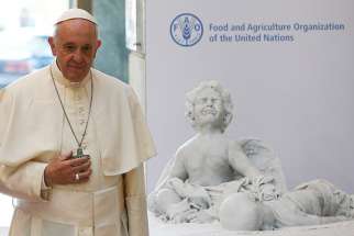 Pope Francis presents the U.N. Food and Agricultural Organization with a marble statue during his visit to FAO headquarters Oct. 16. It is a statue of Alan Kurdi, the 3-year-old Syrian boy who drowned during a Mediterranean crossing in September 2015. 