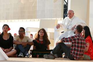  In this 2016 file photo, World Youth Day pilgrims sit in front of Pope Francis at the Field of Mercy in Krakow, Poland. 