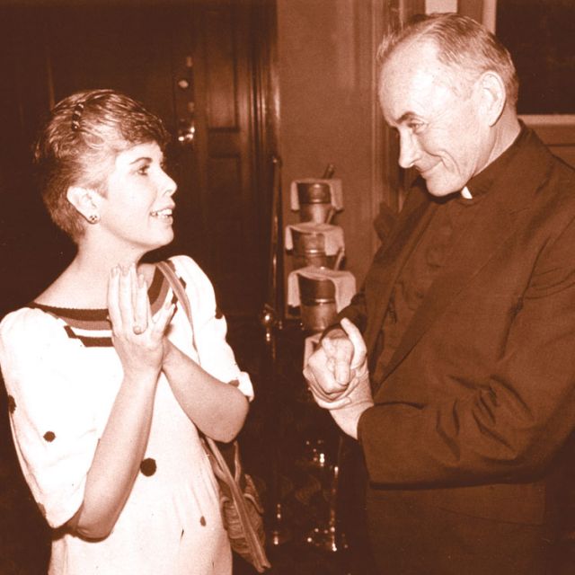 Fr. Andrew Greeley is pictured in a 1985 photo during a reception in his honour in Chicago.