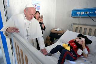 Pope Francis greets a patient during an unannounced visit to the Palidoro Bambino Gesu Hospital, in Fiumicino, outside Rome, in this Jan. 5, 2018, file photo. 