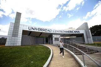 A woman leaves the Jesuit-run Central American University in Managua, Nicaragua, Aug. 16, 2023. The university suspended operations Aug. 16 after Nicaraguan authorities branded the school a &quot;center of terrorism&quot; the previous day and froze its assets for confiscation.