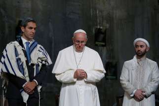 Pope Francis stands between Jewish and Muslim religious leaders during a prayer service at the ground zero 9/11 Memorial Museum in New York Sept. 25. Father John W. Crossin, executive director of the Secretariat for Ecumenical and Interreligious Affairs of the U.S. Conference of Catholic Bishops said, &quot;This event is symbolic and is iconic. It&#039;s a healing message.&quot; 