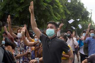 Anti-coup protesters flash the three-finger salute during a protest in Yangon, Myanmar, June 3, 2021. A third church in Kayah state, a Catholic stronghold in eastern Myanmar, was damaged by indiscriminate shelling by the military June 6.