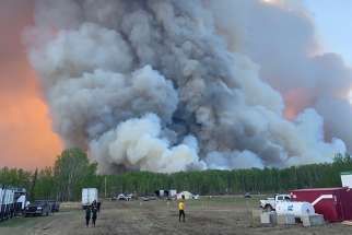A forest fire is seen near High Level, Canada June 3, 2019. About 10,000 people in northern Alberta have been forced to evacuate since May 20 because of a series of spring wildfires.