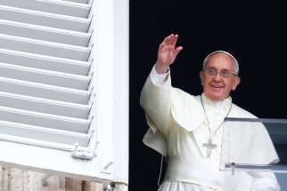 Pope Francis waves as he leads his July 13 Angelus prayer in St. Peter&#039;s Square at the Vatican.