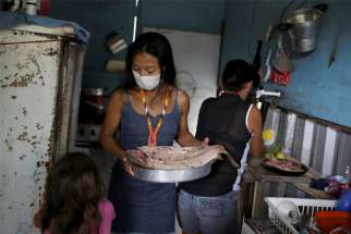 Vanderlecia Ortega dos Santos is seen with her family in their kitchen in Manaus, Brazil, May 7, 2020. Santos is a nurse who has volunteered to provide the only frontline care protecting her indigenous community of 700 families during the COVID-19 pandemic.