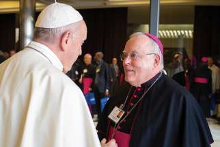 Pope Francis greets Archbishop Charles J. Chaput of Philadelphia before a session of the Synod of Bishops on young people, the faith and vocational discernment at the Vatican Oct. 16.