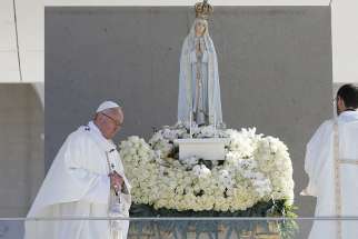 Pope Francis uses incense as he venerates a statue of Our Lady of Fatima during the canonization Mass of Sts. Francisco and Jacinta Marto, two of the three Fatima seers, at the Shrine of Our Lady of Fatima in Portugal, May 13. The Mass marked the 100th anniversary of the Fatima Marian apparitions, which began on May 13, 1917. 