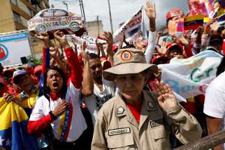 Supporters of Venezuelan President Nicolas Maduro are seen in Caracas, Venezuela, Jan. 10 during his swearing-in ceremony. The Venezuelan bishops&#039; conference has labeled his new government &quot;illegitimate&quot; and called for a &quot;change in government.&quot; 
